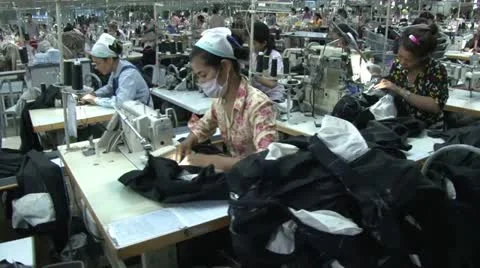 Textile Garment Factory Workers: Dolly type move along aisles of workers Stock Footage