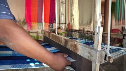 Textile hispanic weaver craftsman making products on a wooden handicraft loom Stock Footage 202228649