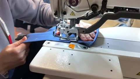 Textile industry. Loops and buttons. Industrial sewing equipment, a machine for Stock Footage 296074727