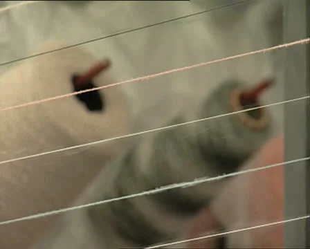 TEXTILE MACHINERY spools of threads rackfocus Video stock 25053102