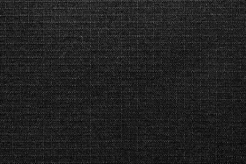 Textile. The material is gray or black in a small check. Fabric background wi Stock Photos