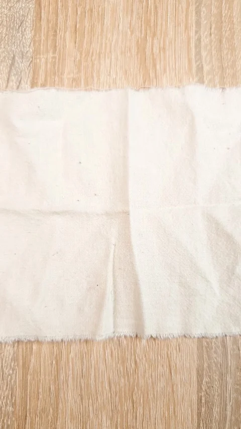 Textile material vertical top view. A light-colored, crumpled Stock Footage 347090293