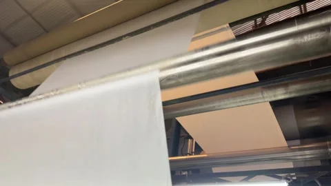 Textile merchandising machine processing white fabric in modern industrial facto Video stock 328002989