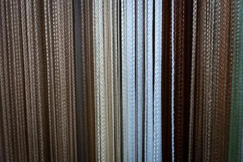 Textile strings and ropes hangs in a fabric shop. Abstract background. Stock Photos