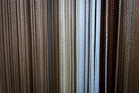 Textile strings and ropes hangs in a fabric shop. Abstract background. Stock Photos