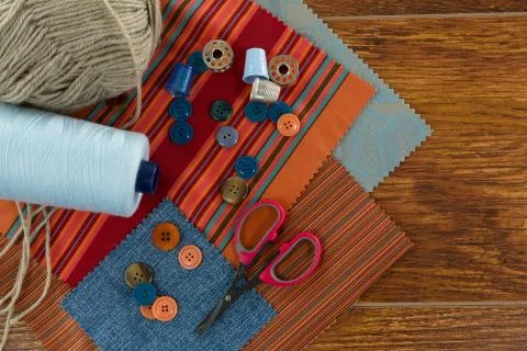 Textile, thread rolls and various equipments on a table Stock Photos