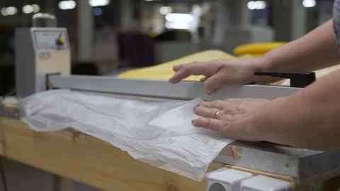 Textile worker at her workplace, packaging of fabrics for transportation Stock Footage 150701833