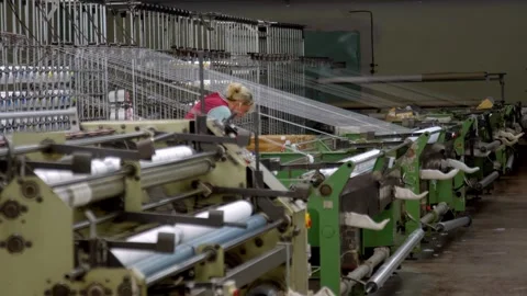 Textile Worker Operating and Inspecting Machines in Fabric Factory Video stock 321152177