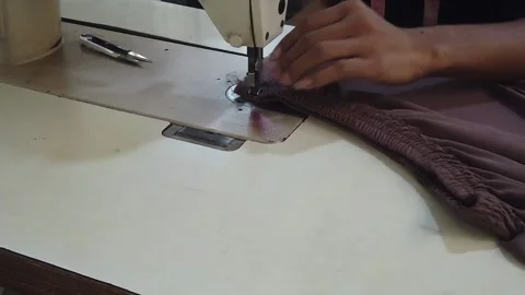 Textile worker sewing cloth in developing country Stock Footage 179429990