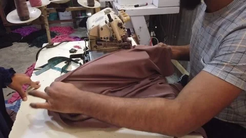 Textile worker sewing cloth in developing country Stock Footage 179429991