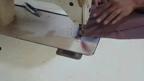 Textile worker sewing cloth in developing country Stock Footage 179432140