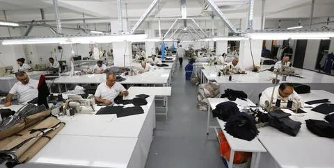 Textile workers work in a textile factory Stock Photos