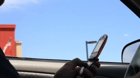 Texting and driving on a cellphone Stock Footage 24744216