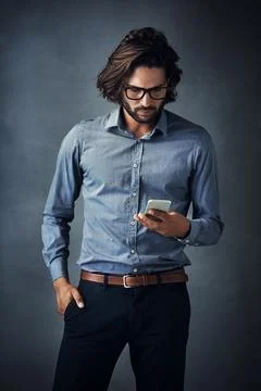 Texting on the fly. Studio shot of a handsome young man using a digital tablet Stock Photos
