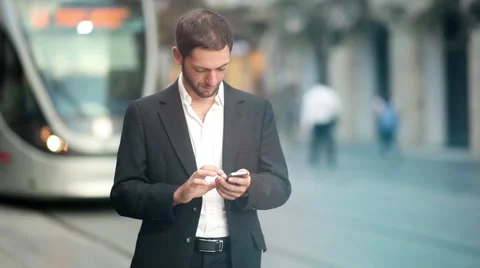 Texting on iphone downtown [slider shot and lens flare] Stock Footage 42253901
