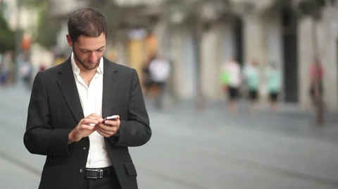 Texting on Iphone downtown [slider shot] Stock Footage 42253906