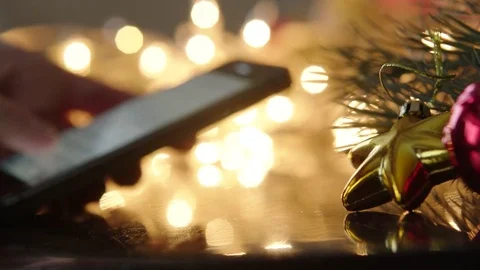 Texting a message on phone on Christmas night, New Year night Stock Footage 71633547