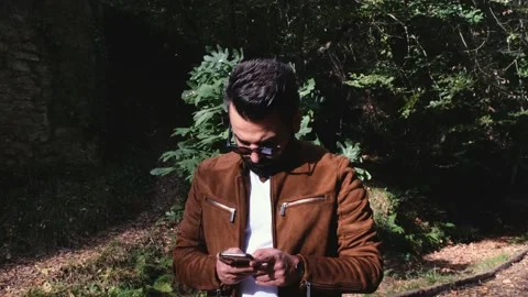 Texting phone, young man texting on cell phone, mobile phone Stock Footage 166016066