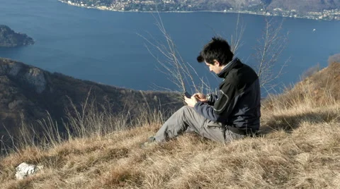 Texting with smartphone in Mountain Stock Footage 59706472