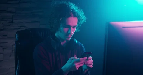 Texting while sitting behind a computer desk Video stock 104222553