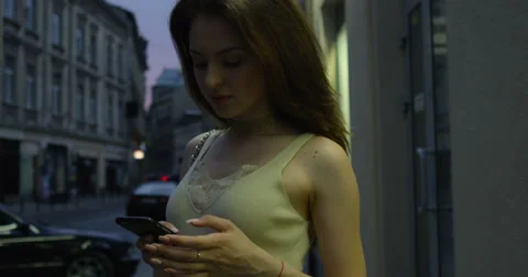 Texting woman on a smartphone device shot on RED Cinema Camera Stock Footage 66432402
