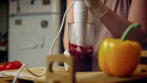 Textural cook peeling a roasted beet from crinkled foil in side view, 4K Stock Footage 341111443