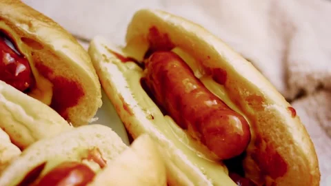 Textural fork holding a cooked sausage above ketchup in wide view, 4K Vídeos de archivo 341116842