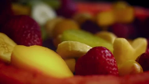 Textural hands cutting star shapes from mango slices in wide view, 4K Stock Footage 341115085