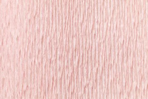 Textural light pink background of wavy corrugated paper, close-up. Stock Photos