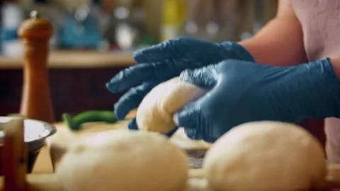 Textural minced meat spooned into a long dough shell in kitchen, 4K Stock Footage 341113895
