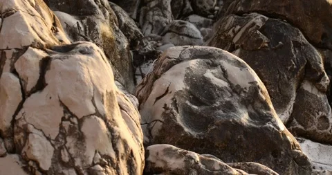 Textural stone rocks on the shore of the adriatic sea at sunset. close-up Stock Footage 241791605