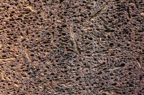 Texture Abstract background of brown pitted rock surface showing natural geol Stock Photos