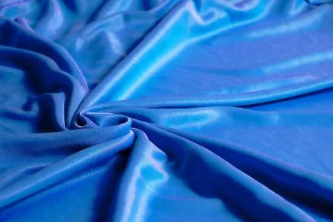 Texture, abstract background, silk blue fabric artistically laid out. Stock Photos