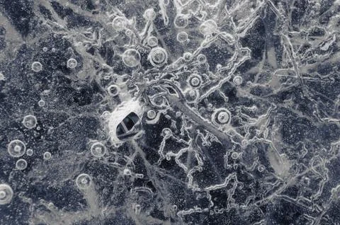 Texture abstract closeup background ice with grooves, furrows, and bubbles of Stock Photos