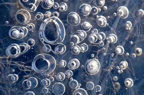 Texture abstract closeup background ice with bubbles of air caught by frost in Stock Photos