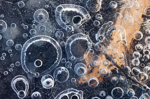 Texture abstract closeup background ice with bubbles of air caught by frost in Stock Photos