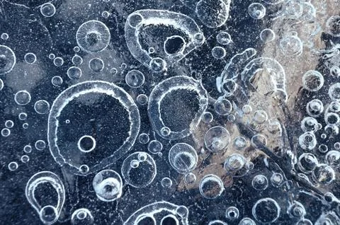 Texture abstract closeup background ice with bubbles of air caught by frost in Stock Photos