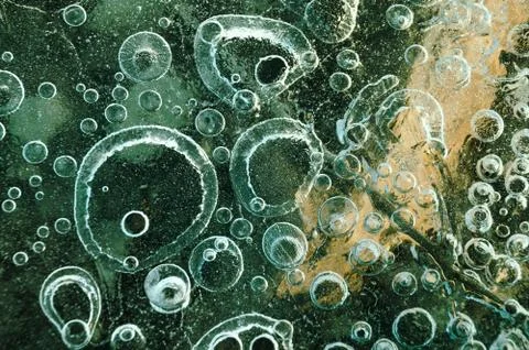 Texture abstract closeup background ice with bubbles of air caught by frost in Stock Photos