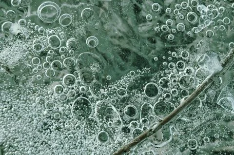 Texture abstract closeup background ice with bubbles of air caught by frost in Stock Photos