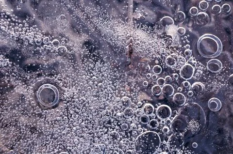Texture abstract closeup background ice with bubbles of air caught by frost in Stock Photos