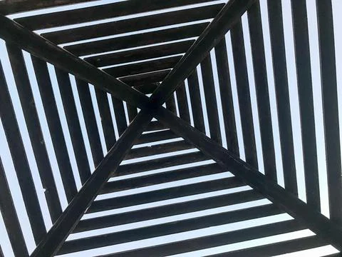 Texture abstract triangular dark brown wooden logs of logs, planks, beams in  스톡 사진