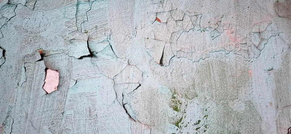 The texture of an aged wall with peeling paint. Stock Photos