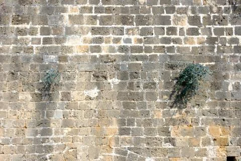 Texture of the ancient stone wall of the ancient city Stock Photos