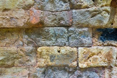 Texture of an ancient wall from a stone brick Stock Photos