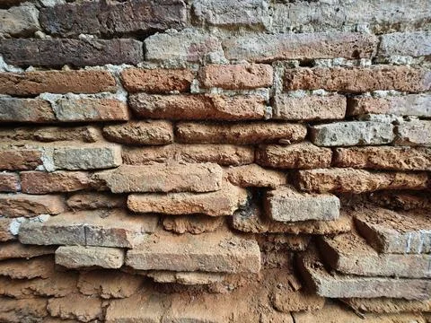 Texture of an ancient weathered red brick wall. Stock Photos
