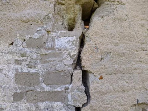Texture and background of an old brick wall that is cracked in half. Stock Photos