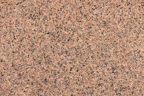 Texture and background of spotted granite wall in brown color. Stock Photos