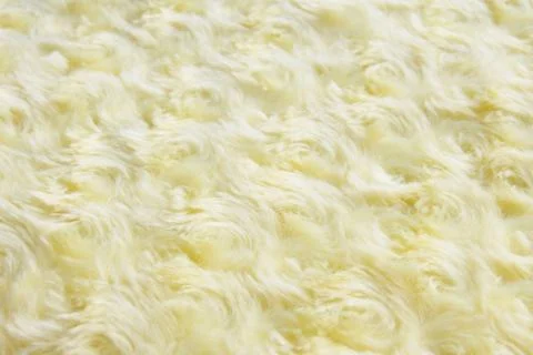 Texture and background of yellow artificial fur with round curls.. Stock Photos