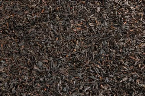 Texture and full frame background of flat heap of dry long-term black tea Stock Photos