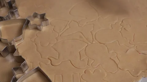 Texture and pattern of festive cookie shapes cut into raw gingerbread dough. Stock Footage 311807044